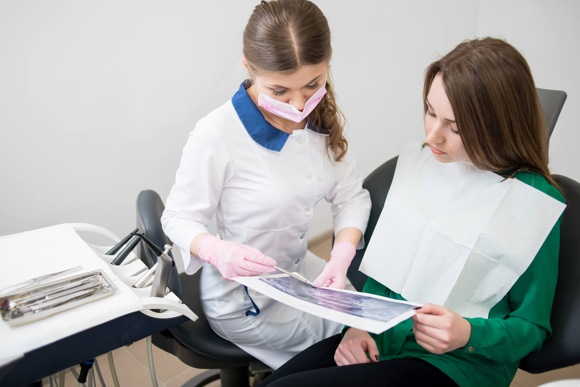 An emergency dentist in Hialeah showing x-rays to a patient