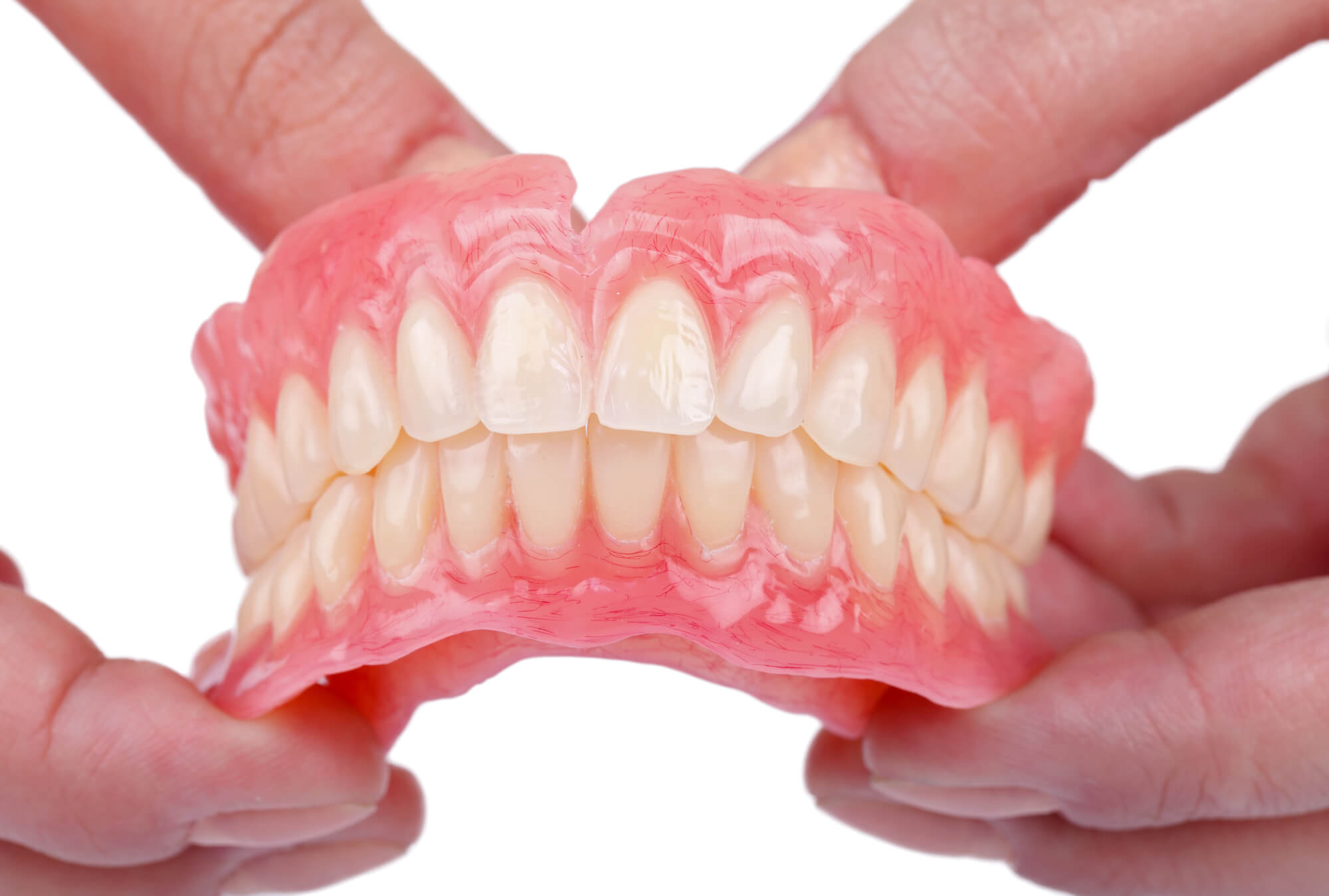 Close up of hands holding dentures in Pembroke Pines