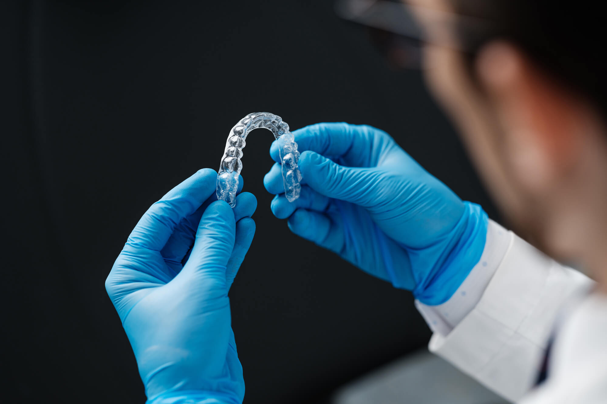 a miami orthodontic specialist holding clear aligners
